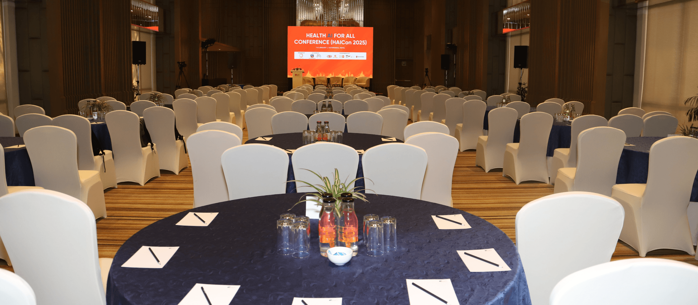 Empty HAICon conference hall with podium and banner